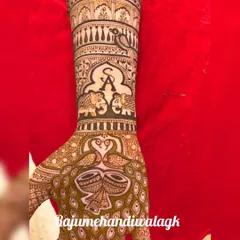 A personalized bridal mehandi featuring the couple's initials 'S' and 'A' within an arch. It also includes elephants, dholkis (drums), and peacocks, blending personal touches with traditional wedding symbols.