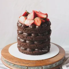 A naked chocolate cake with layers of rich chocolate ganache, topped with fresh strawberries. The combination of chocolate and berries is a classic for a reason.