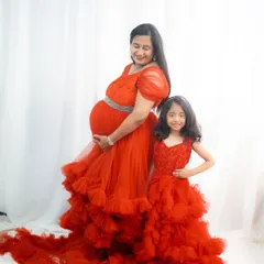 I love creating matching outfits for the whole family. This mother and daughter duo in coordinated red ruffle gowns is a perfect example of how you can create beautiful, coordinated memories for maternity shoots or family functions.
