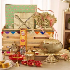 I designed this festive hamper with a mix of traditional and decorative items, including a brass incense holder, a lidded serving dish, colorful diyas, and beautifully wrapped gifts in a decorated wooden crate.