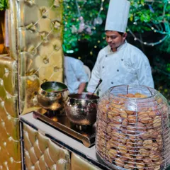 A chef at the pani puri station, a key attraction of the chaat counter, with a display of crispy puris.