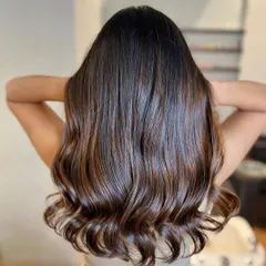 This chocolate brown balayage is rich and luxurious. It's a timeless look that adds incredible shine and dimension to dark hair.
