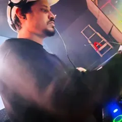 In the zone, completely focused on the music and the crowd's reaction. For me, DJing is about creating a shared experience, one track at a time.