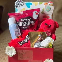 A classic romantic gesture in a box. This hamper is curated with love, featuring a bright red theme, a soft teddy bear, Hershey's Kisses, and other treats to say "I love you" in the sweetest way possible.