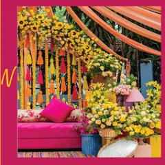 I love elevating Mehendi decor with a pop of pink amidst a sea of yellow blooms. This setup combines a plush pink sofa with an abundance of sunflowers and marigolds for a cheerful and energetic celebration.