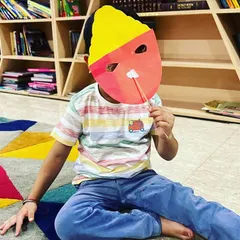 A child trying on his finished Ravan mask. We learned fun facts about the story of Ramayana before our craft session.