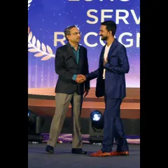 A moment of appreciation on stage, shaking hands after my sand art performance. I'm always grateful for the respect and honor I receive at these corporate functions.
