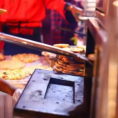 Freshly baked pizzas coming straight out of the oven at one of our events. Our live pizza station is perfect for adding a touch of Italian flair, serving hot and delicious oven-baked pizzas to your guests.