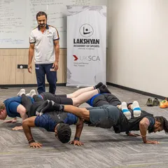 A fun, practical team-building exercise during a UKSCA course, demonstrating creative ways to think about bodyweight strength and conditioning.