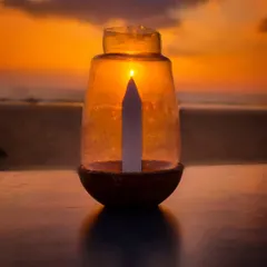 Another one of my creative sunset experiments. By placing a candle in a glass jar, I aligned it with the setting sun to make it seem as if the sun is the candle's flame.