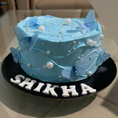 This beautiful cake features a dreamy blue wave frosting design, adorned with delicate blue butterflies and white pearls. It's a serene and elegant option that's very popular on Pinterest and Instagram.