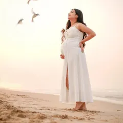 There is a serene beauty in motherhood. We captured this quiet moment of reflection for a mama-to-be during a golden hour beach session.