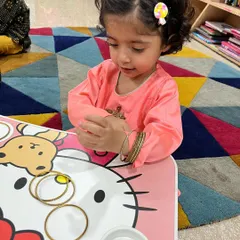 This little girl is exploring bangles during our Diwali celebrations. We incorporate sensory play and traditional items to make the festival experience rich and tangible for the toddlers.