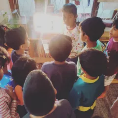 The children gather to candle the eggs, using a bright light to observe the developing embryos inside. This magical process makes the abstract concept of life's beginning tangible and awe-inspiring.