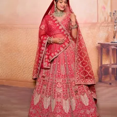 A full-length view of a traditional bride in a magnificent red lehenga. The makeup is designed to be radiant and balanced, ensuring she looks breathtaking from every angle.