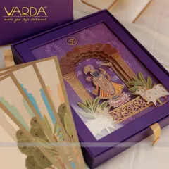 We designed this Shreenathji-themed wedding invitation box with divine artistry. The rich purple box opens to reveal a stunning 3D depiction of Lord Shrinathji, blending sacred tradition with luxurious, detailed craftsmanship for a truly memorable wedding announcement.
