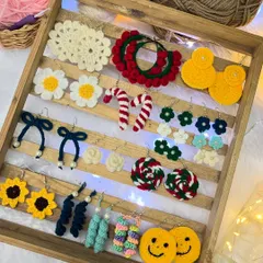 Here is a tray showcasing the wide variety of earrings I can make. From smiley faces and candy canes to daisies and sunflowers, there's a design for every personality.