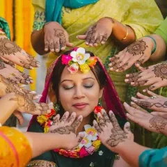 A beautiful, candid moment from a mehndi ceremony. The bride is surrounded by her loved ones, each with their own unique henna design. We help create these picture perfect memories.