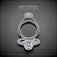 This design is a masterpiece of detail, featuring a central brilliant diamond held within an intricately crafted halo and band. It is a ring designed for a love story that is grand and beautiful.