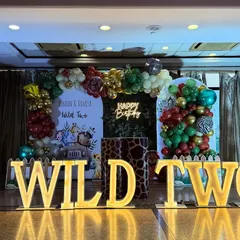 A straight-on shot of the "Wild Two" stage, highlighting the custom backdrop and the detailed animal-print plinths used for display.