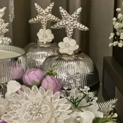 A closer look at the elegant silver decor pieces we use in our luxury hampers. The starfish toppers and intricate glass jars add a touch of sophistication to any gift.