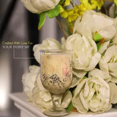 Crafted with love for your every sip. Another elegant shot of our classic Falooda, presented beautifully against a floral background.