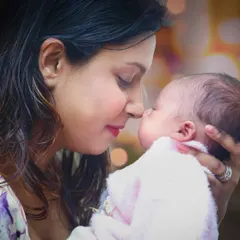A tender moment captured between a mother and her newborn baby, nose to nose.