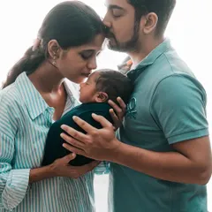 Capturing the quiet, intimate moments right after birth. Here, both parents embrace their newborn, creating a powerful image of family unity and love.