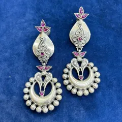 Pure silver chandelier earrings with a traditional design. This pair features intricate silver work with peacock motifs and pink stone accents, creating a beautiful dangling effect.
