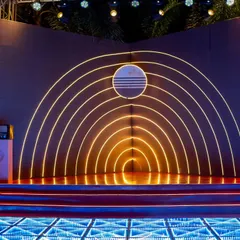 A stage that was out of this world. The orbit-inspired concentric neon arches created a cosmic focal point, set инноваate an infinity-mirror LED dance floor for a truly immersive experience.
