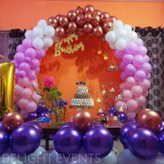 Another look at our popular purple and pink home setup, this time with the birthday cake as the centerpiece. The multi-tiered cake sits perfectly within the colorful balloon arch, showing how we integrate all elements of your party.