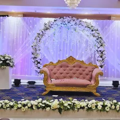 A closer look at the ring ceremony stage. The circular floral arch is complemented by hanging crystal strings and soft purple and white lighting.