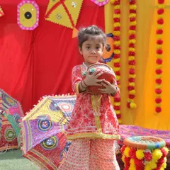 Dressed in her festive best for Baisakhi. This little star is holding a traditional pot, surrounded by the vibrant colors of our Punjabi harvest festival setup.
