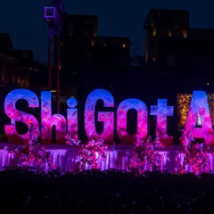 A large, custom-made sign of the wedding hashtag '#ShiGotAbhi' becomes a central decor element, lit up in vibrant colors for the sangeet night.