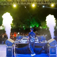A shot from behind the decks at Mansarovar Global University. The twin CO2 jets create a powerful visual frame for my performance.
