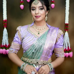 This elegant look features a layered diamond and emerald-look necklace set against a beautiful lavender saree. It's a sophisticated choice for a modern bride or wedding guest.