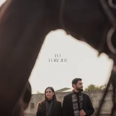 An artistic shot from the equestrian shoot, framed through the horse's bridle. This creative composition adds a layer of intimacy and a unique perspective to the couple's portrait.
