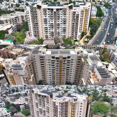 A multi-angle aerial view of a large residential building in Bengaluru, showcasing a comprehensive rooftop solar installation by EcoSoch Solar.