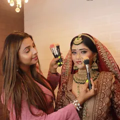 A behind-the-scenes shot with our artist and a model during a demonstration. We believe in a hands-on approach to both our services and our teaching.