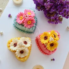 These heart cake candles are topped with vibrant, hand-poured daisy flowers. The combination of the cake shape and floral decoration makes them a truly unique birthday gift.