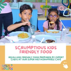 I provide scrumptious, kid-friendly food prepared by expert chefs at our super Instagrammable cafe. This picture shows kids enjoying a tasty meal of noodles and pizza.