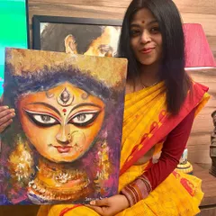 Me holding my completed Durga painting. The use of bold colors and expressive brushstrokes in acrylics captures the powerful yet compassionate nature of the goddess.