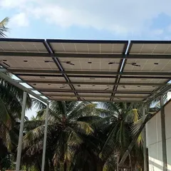 The completed 5kW on-grid solar panel installation in Dharwad. The panels are mounted on a custom-designed pergola structure, which also provides shade for the rooftop area.