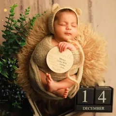 A personalized birth announcement photo for baby Miraya. We incorporate custom props like this wooden "hello world" sign and date blocks to create a unique keepsake that captures all the important details of her arrival.
