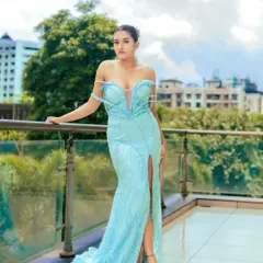 Showcasing a stunning, icy blue gown for designer Dilnar. This outdoor shot uses natural light to make the sequined fabric sparkle, perfect for a luxury brand lookbook.
