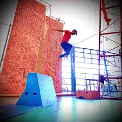 A snapshot of a precision jump in action. A huge part of parkour is learning to accurately judge distances and commit to the leap, building both physical power and mental focus.