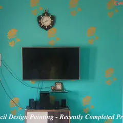 We completed this project featuring a floral stencil design in yellow over a teal accent wall. This combination of colors and pattern adds a fresh and stylish touch to the TV area.