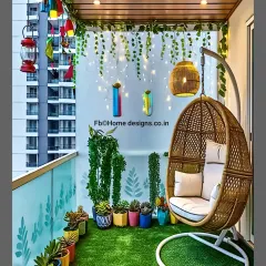 This cozy balcony features a comfortable swing chair, artificial turf, and hanging fairy lights. The colorful planters and lanterns add a bohemian and whimsical touch.