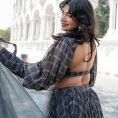 A closer look at the back of our grey plaid lehenga. The open-back design adds a modern, edgy touch.