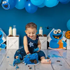 Digging into the cake with a happy grin. Cake smash sessions are all about letting kids be kids and capturing their genuine reactions.